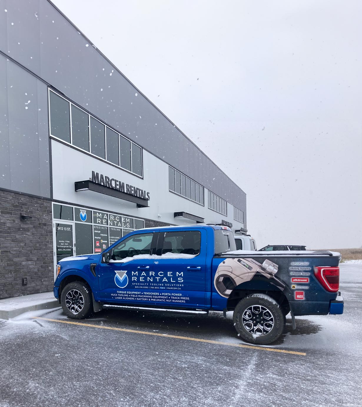 Marcem Canada snowing and blue truck outside the Marcem Canada headquarters